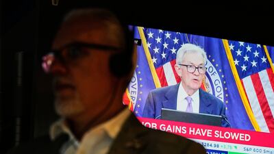 Federal Reserve Chair Jerome Powell speaks on a screen on the floor of the New York Stock Exchange, after the US central bank cut interest rates on Wednesday. AP
