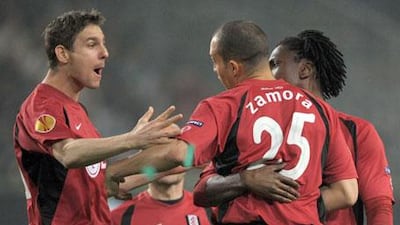 FC Fulham's Zoltan Gera, left, celebrates with teammate Bobby Zamora, centre, after scoring against VfL Wolfsburg during their Europa League quarterfinals game in Wolfsburg, Germany, on Thursday, April 8, 2010.