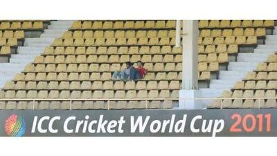 Two fans attempt to fill the stands in the Australia-Zimbabwe game at the 55,000-capacity Sardar Patel Gujarat Stadium in Ahmedabad on Monday.