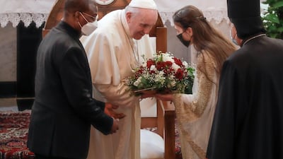 Pope Francis is welcomed upon his arrival at the Our Lady of Salvation Church. AP Photo