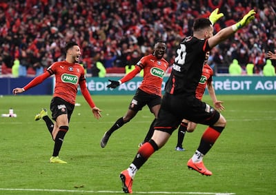 Rennes celebrate after PSG's Christopher Nkunku failed to score during the penalty shootout. Anne-Christine Poujoulat / AFP