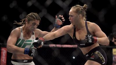 UFC bantamweight champion Ronda Rousey shown throwing a punch at Brazil's Bethe Correia during her title defence in August in Rio de Janeiro. Alexandre Loureiro / Inovafoto / AP / August 2, 2015