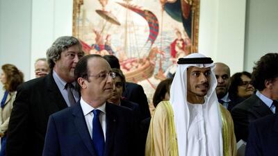 Sheikh Sultan bin Tahnoon, chairman of the Tourism and Cultural Authority Abu Dhabi, and the French president Francois Hollande at the launch of the Birth of a Museum exhibition at the Louvre in Paris. Alain Jocard / AFP