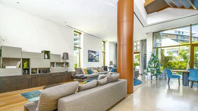 A big brown pillar dominates the lounge. Courtesy LuxuryProperty.com