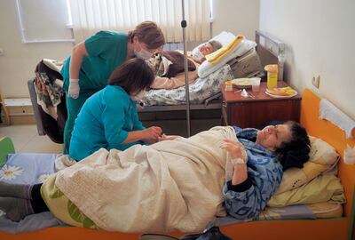 Nurses administer medicine to a patient wounded from shelling by Azerbaijan's artillery in a hospital, during a military conflict in Stepanakert, the separatist region of Nagorno-Karabakh, October 17. AP