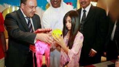 Jude al Qubaisi, 10, receives a Hadaaf savings box at the launch of the campaign in Abu Dhabi.