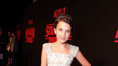 Millie Bobby Brown, wearing a golden tulle-skirted dress, attends the 'Stranger Things' premiere in Los Angeles on July 11, 2016. AP Photo