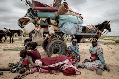 A Sudanese family who fled the conflict in Sudan's Darfur region sit beside their belongings while waiting to be registered by the UN after crossing the border into Chad. Reuters