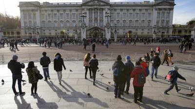 People take pictures in front of Buckingham Palace on November 18, 2016. Tim Ireland/AP Photo