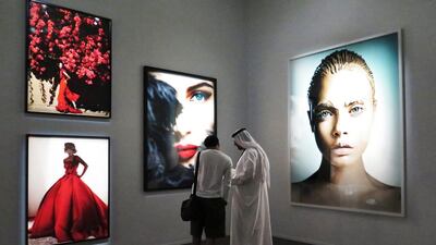 Fans visit a collection titled "Heat" of Peruvian fashion and portrait photographer Mario Testino in Dubai. Kamran Jebreili / AP