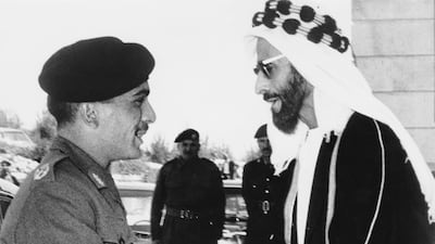 King Hussein of Jordan, left, greets Sheikh Shakhbut bin Sultan Al Nahyan upon his arrival at the Officers' Club in Zerqa, Jordan, April 1966. Getty Images