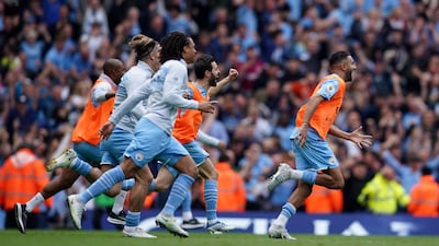 Manchester City players celebrate after winning the Premier League. AP