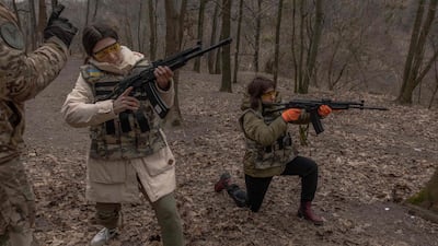 Ukrainian civilian women are trained to use weapons, in Kyiv. AFP