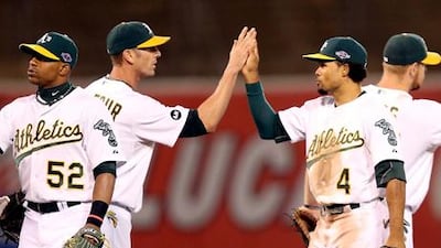Grant Balfour and Coco Crisp celebrate after Oakland defeat Detroit in game three of their playoff series