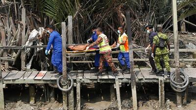 A survivor from an overloaded wooden boat which sank off Malaysia carrying dozens of Indonesian illegal immigrants is carried away a stretcher by the Malaysian Fire and Rescue department. Samsul Said / Getty Images