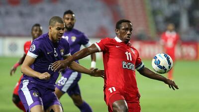 Al Ain's Ismail Ahmed, left, and Al Ahli's Ahmed Khalil tussle for the ball during the first leg of the Asian Champions League last-16 tie. Pawan Singh / The National