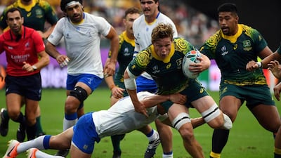 Uruguay wing Nicolas Freitas tackles Australia flanker Michael Hooper. AFP