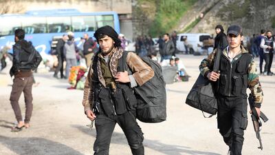 Rebel fighters are seen upon their arrival in the Qalaat Al Madiq village in the province of Hama, on March 13, 2018, after being evacuated from the Qadam neighbourhood on the outskirts of Damascus under a deal agreed between the government and opposition fighters. Omar Haj Kadour / AFP