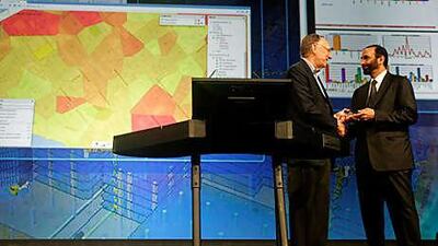 Mohammed Ahmed al Bowardi, right, receives an award at the ESRI International User Conference on behalf of Abu Dhabi.