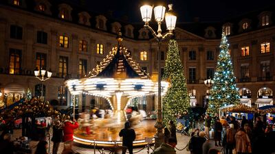 A carousel spins among the Christmas trees on Place Vendome in central Paris. AFP