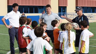 Brian O'Driscoll, centre, and fellow HSBC Sporting Ambassador, former tennis player Tim Henman, left, take a coaching clinic prior to the start of the Abu Dhabi HSBC Golf Championship. Courtesy of HSBC/Getty Images