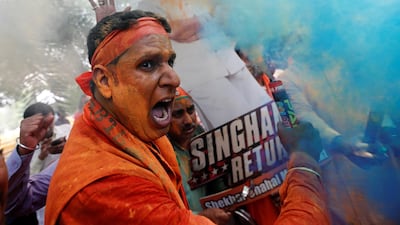 BJP supporters celebrate after learning the initial election results outside the party headquarters in New Delhi. REUTERS