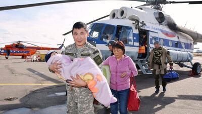 A rescuer carryes three-year-old Tserin, who went missing in the Siberian Taiga area and was found three days later in Tyva region, Russia. Russian Emergencies Ministry / handout, Reuters
