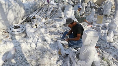 A man sculpts marble stones into a Buddha statue at a marble mine at Zagyin village. Soe Zeya Tun / Reuters