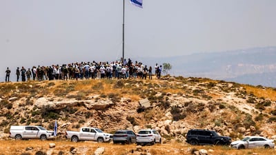 Settlers accompanied by Israeli Finance Minister Bezalel Smotrich during a ceremony for a new illegal settlement on Mount Tarousa, near Hebron. Israel has announced plans to build on Palestinian land in the area. AFP