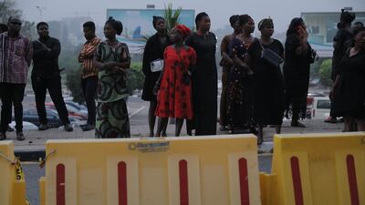 Family members wait for the arrival of the coffin containing the remains of former Ghana international football player Christian Atsu at the Kotoka International Airport in Accra, Ghana. AFP
