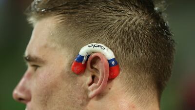 Jason Woodward, of the Rebels, wears his mouthguard on his ear during the game. Scott Barbour / Getty Images