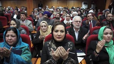 Afghan parliamentarians pray during the opening of the new parliament in Kabul.
