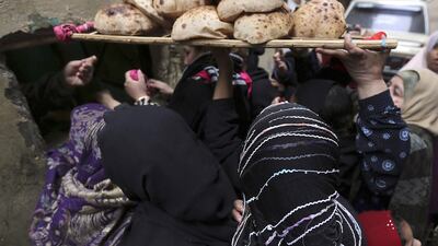 Women purchase subsidised bread through a window at a bakery in Cair. Mohamed Abd El Ghany / Reuters