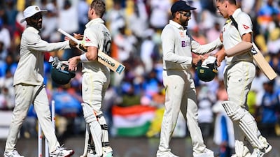 India's players shake hands with the Aussies after the conclusion of the first Test. AFP
