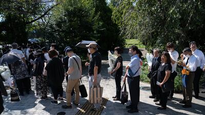 The queue to leave flowers at a park near the Nippon Budokan, where Abe's funeral was held. Getty