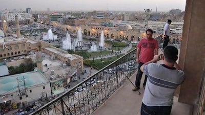 Tourists take photographs at Erbil's Citadel. Rosemary Behan / The National