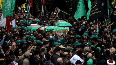 The coffin of Mr Al Arouri is carried through the streets. Getty Images