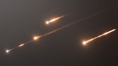 Rocket contrails appear in the sky above Jerusalem. AFP