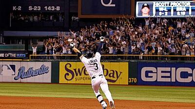 Evan Longoria celebrates rounding the bases at the bottom of the 12th inning after his home run helped Tampa Bay Rays come from 7-0 down to beat the New York Yankees and seal their place in the play-offs.