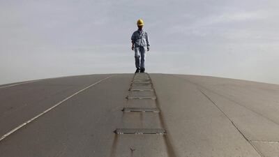 Above, a worker on top of an oil tank at a Sinopec refinery in Hubei province. China’s oil demand has exploded to a record above 8 million barrels per day in February this year from 2 million barrels per day a decade ago. Reuters