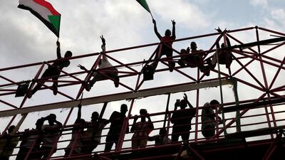 Sudanese civilians wave their national flags during celebrations of the signing of the Sudan's power sharing deal,. REUTERS/Mohamed Nureldin Abdallah