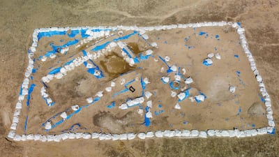 An aerial picture shows a general view of the newly-excavated trench which may have contained an inn with a cooling area for food storage, at the site of the ancient city-state of Lagash, in Iraq's al-Shatra district of the southern Dhi Qar province on February 11, 2023. - Italian and US archaeologists excavating in Lagash in southern Iraq have unearthed a Sumerian "tavern" old nearly 5,000 years old, complete with benches, a cooling system acting as a refrigerator, and bowls containing leftover food. (Photo by Asaad NIAZI / AFP)
