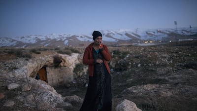 Dalal, 21, a refugee from Damascus, in front of the cave in Lebanon she and her family were staying in, 2013. Courtesy Lynsey Addario