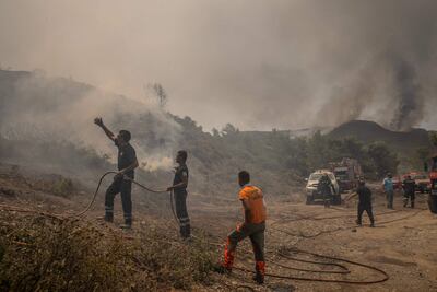 Firefighters tackle a blaze in Rhodes. AFP