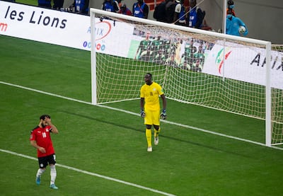 Mohamed Salah, left, reacts after failing to score his penalty kick against Senegal's goalkeeper Edouard Mendy. AP Photo