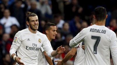 Gareth Bale, left, scored the first four-goal haul of his career to guide Real Madrid to victory over Rayo Vallecano. Sergio Perez / Reuters