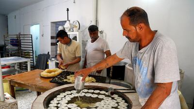 Workers prepare traditional sweets for sale during Ramadan at a shop in Najaf, Iraq. Reuters