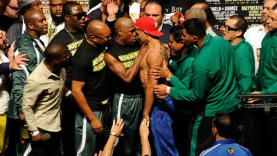 Mayweather grabs the neck of Victor Ortiz after the weigh-in for their WBC welterweight title fight at the MGM Grand Garden Arena on September. Ethan Miller / Getty Images