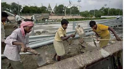 Indian laborers work outside Jawaharlal Nehru stadium, the main venue for the Commonwealth Games,in New Delhi.