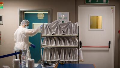 A worker delivers meals to Covid-19 patients who are housed in the Living Place Hotel in Bologna, Italy. Getty Images